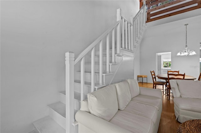 7705 4th Ave W, Bradenton, FL 34209 - living room with stairs, wood finished floors, a chandelier, and a towering ceiling