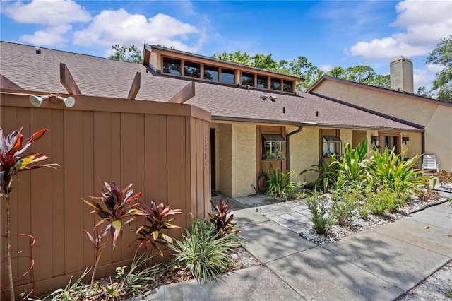 7705 4th Ave W, Bradenton, FL 34209 - view of front facade with roof with shingles and a chimney