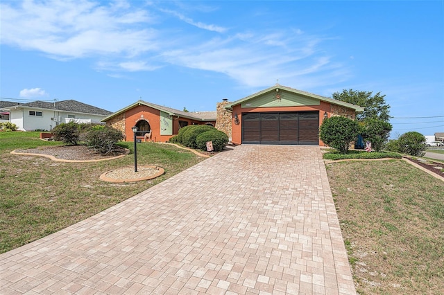 159 Canby Cir, Spring Hill, FL 34606 - ranch-style house featuring decorative driveway, an attached garage, a front yard, and a chimney
