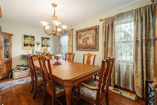 159 Canby Cir, Spring Hill, FL 34606 - dining room featuring a chandelier, a textured ceiling, and wood finished floors