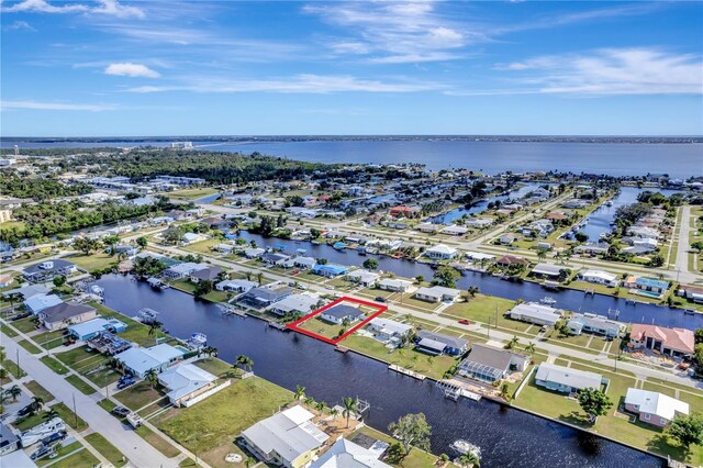 551 Lindley Ter, Port Charlotte, FL 33952 - aerial view of residential area with a nearby body of water and property boundaries highlighted
