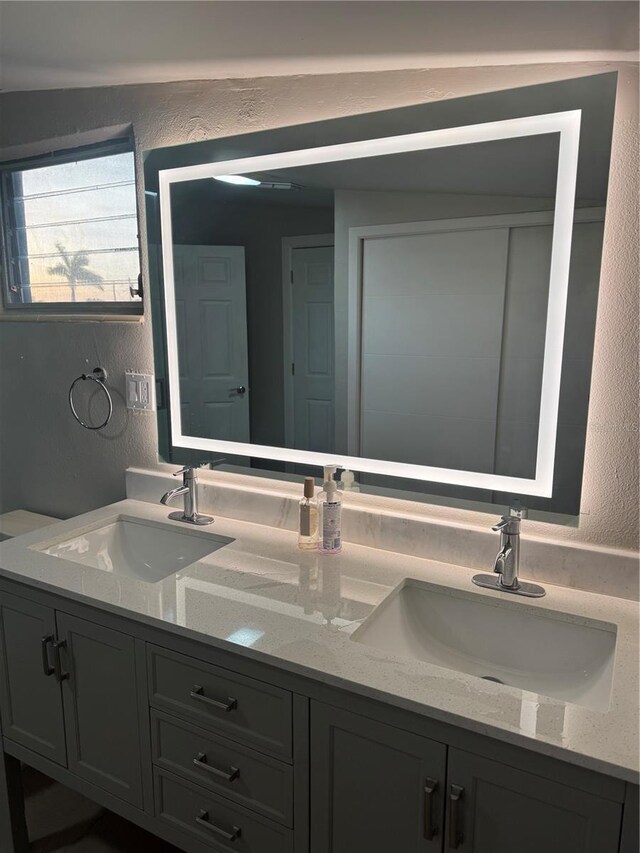 551 Lindley Ter, Port Charlotte, FL 33952 - bathroom with double vanity and a textured wall