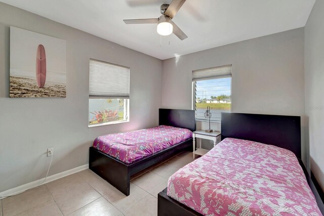 551 Lindley Ter, Port Charlotte, FL 33952 - bedroom with baseboards, tile patterned floors, and a ceiling fan