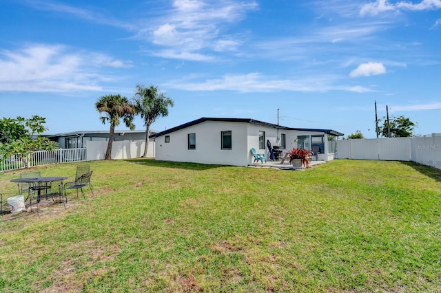 551 Lindley Ter, Port Charlotte, FL 33952 - back of house with stucco siding and a patio