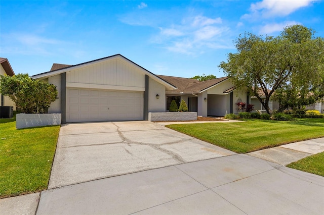 14164 Fennsbury Dr, Tampa, FL 33624 - view of front facade with a garage, a front lawn, driveway, cooling unit, and stucco siding