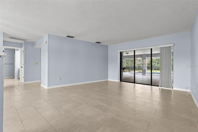 14164 Fennsbury Dr, Tampa, FL 33624 - empty room with a textured ceiling, baseboards, and light tile patterned floors