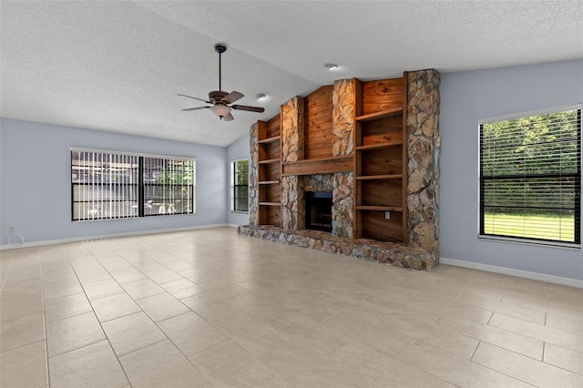 14164 Fennsbury Dr, Tampa, FL 33624 - unfurnished living room with a textured ceiling, a ceiling fan, baseboards, vaulted ceiling, and a stone fireplace