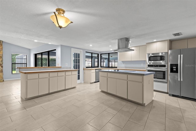 14164 Fennsbury Dr, Tampa, FL 33624 - kitchen featuring appliances with stainless steel finishes, a center island, island exhaust hood, a textured ceiling, and a sink