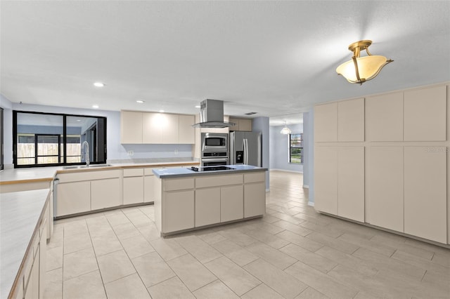 14164 Fennsbury Dr, Tampa, FL 33624 - kitchen with appliances with stainless steel finishes, island exhaust hood, a sink, a kitchen island, and light countertops