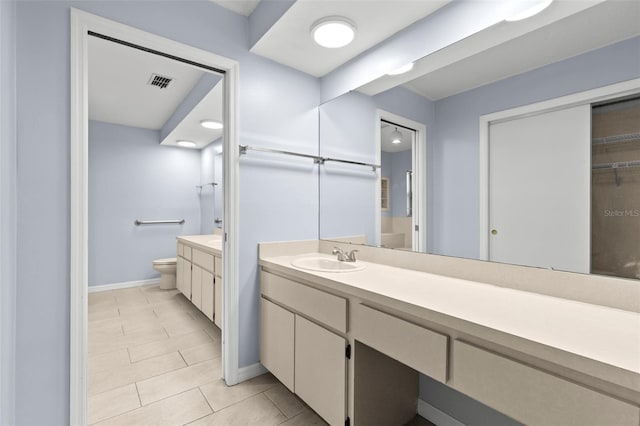 14164 Fennsbury Dr, Tampa, FL 33624 - bathroom featuring vanity, toilet, baseboards, and tile patterned flooring