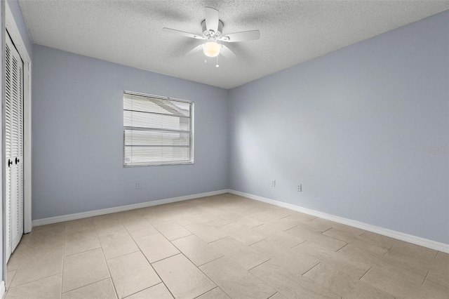14164 Fennsbury Dr, Tampa, FL 33624 - unfurnished bedroom with a closet, a textured ceiling, baseboards, and a ceiling fan