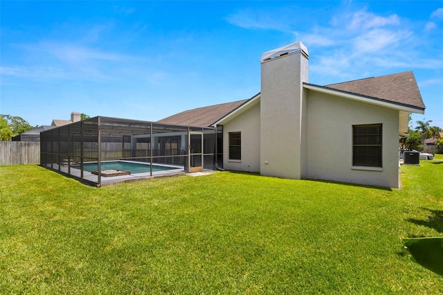 14164 Fennsbury Dr, Tampa, FL 33624 - back of property with stucco siding, cooling unit, glass enclosure, a chimney, and roof with shingles