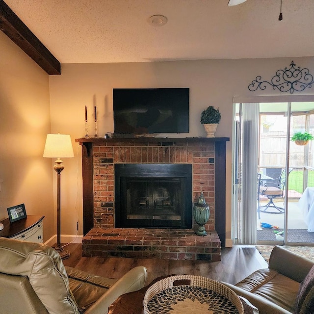 5119 Hector Ct, Tampa, FL 33624 - living area with wood finished floors, beamed ceiling, a brick fireplace, and baseboards