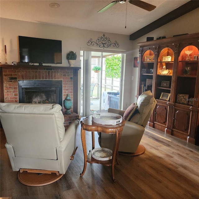 5119 Hector Ct, Tampa, FL 33624 - living room featuring wood finished floors, a ceiling fan, a brick fireplace, and lofted ceiling