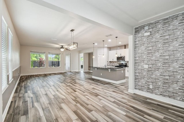 1553 Amber Leaf Cir, Ocoee, FL 34761 - unfurnished living room featuring wood finished floors, baseboards, recessed lighting, and ceiling fan