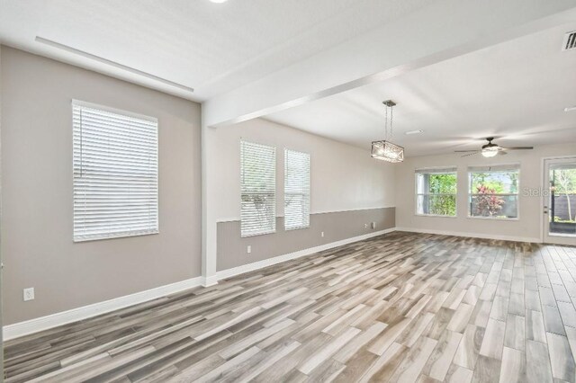 1553 Amber Leaf Cir, Ocoee, FL 34761 - unfurnished living room with wood finished floors, baseboards, a ceiling fan, and a chandelier