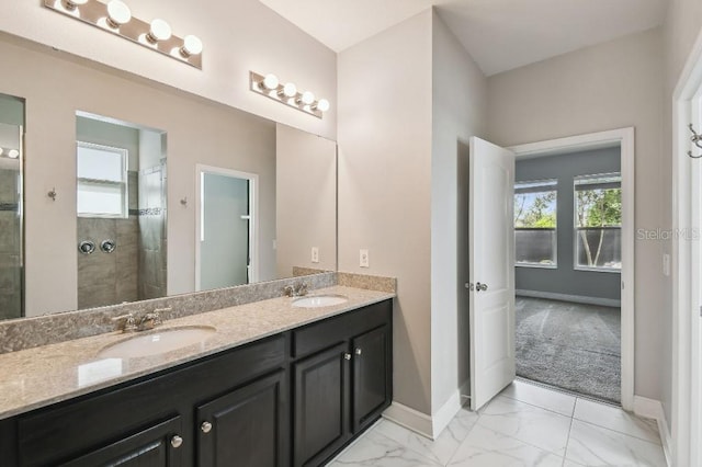 1553 Amber Leaf Cir, Ocoee, FL 34761 - bathroom featuring plenty of natural light, double vanity, baseboards, and a tile shower