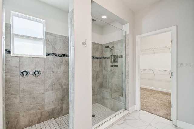 1553 Amber Leaf Cir, Ocoee, FL 34761 - full bathroom featuring a stall shower, a spacious closet, and marble look tile flooring
