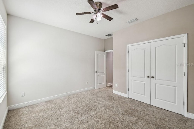 1553 Amber Leaf Cir, Ocoee, FL 34761 - unfurnished bedroom with carpet, a closet, baseboards, a ceiling fan, and multiple windows