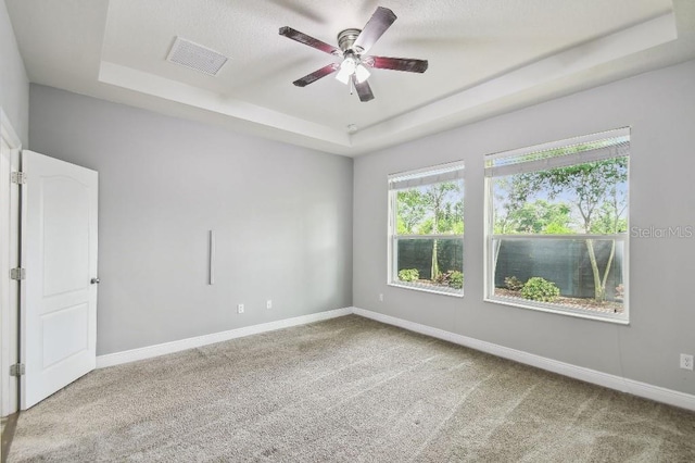 1553 Amber Leaf Cir, Ocoee, FL 34761 - spare room with a tray ceiling, a ceiling fan, carpet, and baseboards