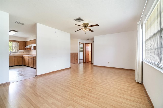 201 W New York Ave, Orange City, FL 32763 - spare room featuring a ceiling fan and light wood-style flooring