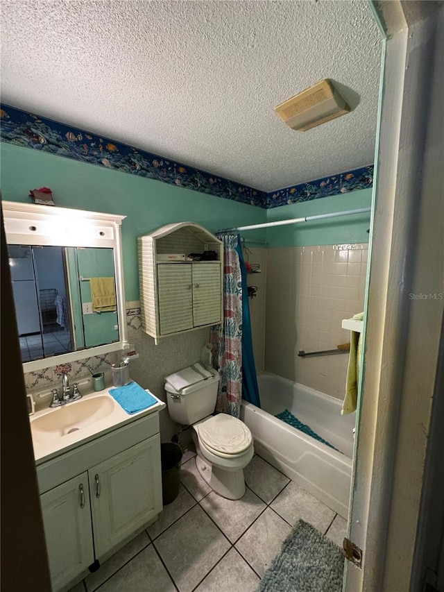 5247 81st St N Unit 2, Saint Petersburg, FL 33709 - bathroom with a textured ceiling, toilet, vanity, shower / tub combo with curtain, and tile patterned flooring