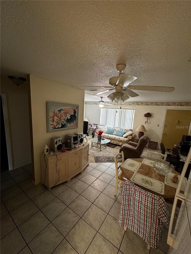 5247 81st St N Unit 2, Saint Petersburg, FL 33709 - living room with ceiling fan, light tile patterned floors, and a textured ceiling