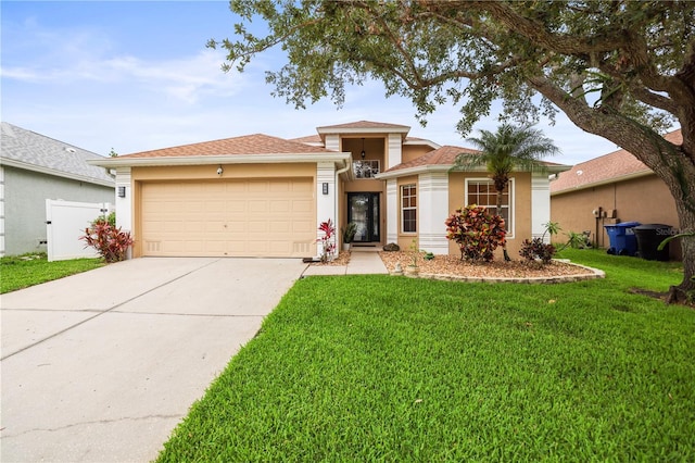 826 Addison Dr NE, Saint Petersburg, FL 33716 - view of front facade featuring stucco siding, a garage, driveway, and a front lawn