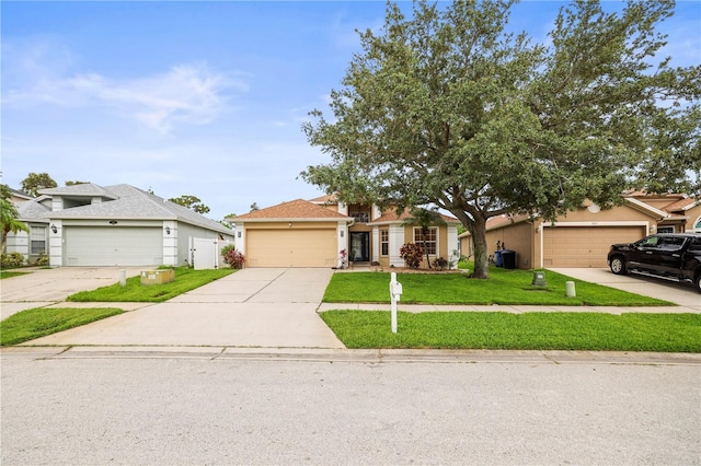 826 Addison Dr NE, Saint Petersburg, FL 33716 - view of front of home with a front yard, stucco siding, and driveway