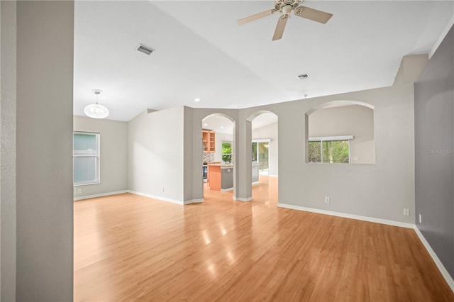 826 Addison Dr NE, Saint Petersburg, FL 33716 - unfurnished living room with vaulted ceiling, ceiling fan, light wood-type flooring, and recessed lighting