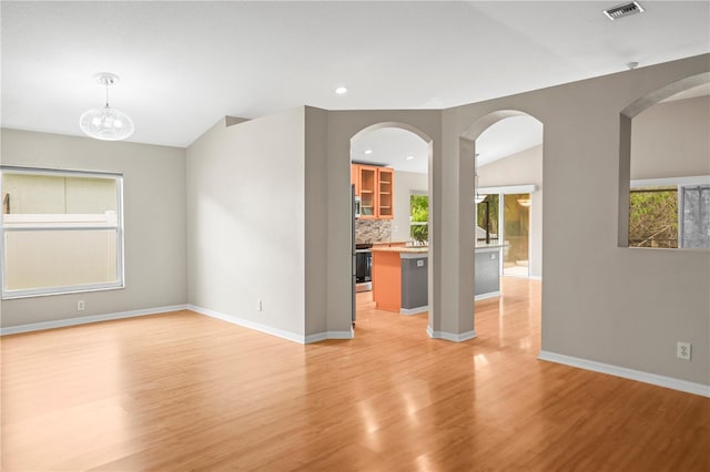 826 Addison Dr NE, Saint Petersburg, FL 33716 - unfurnished living room featuring light wood finished floors and recessed lighting