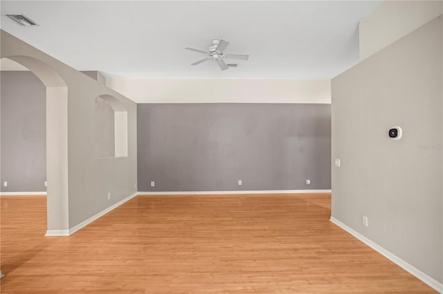 826 Addison Dr NE, Saint Petersburg, FL 33716 - spare room with ceiling fan, light wood-style floors, and arched walkways