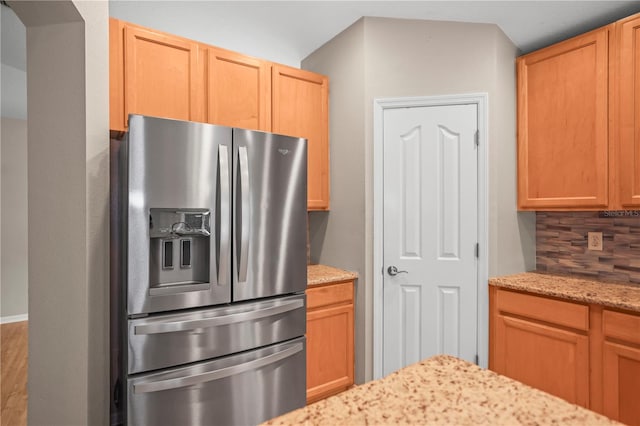 826 Addison Dr NE, Saint Petersburg, FL 33716 - kitchen featuring stainless steel fridge, light stone counters, and decorative backsplash