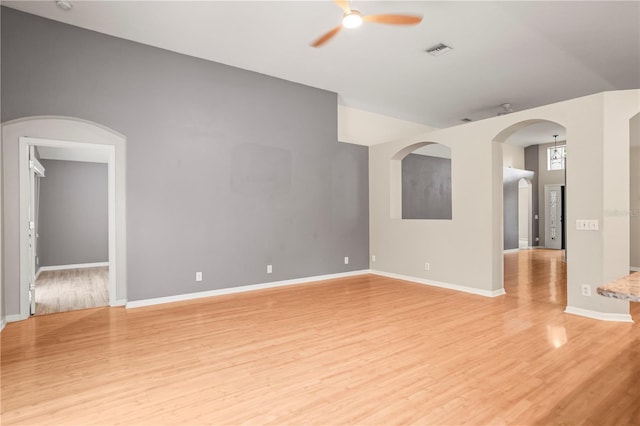 826 Addison Dr NE, Saint Petersburg, FL 33716 - unfurnished room featuring a ceiling fan, light wood-style floors, and arched walkways