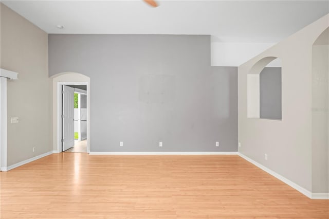 826 Addison Dr NE, Saint Petersburg, FL 33716 - spare room featuring light wood-style flooring and arched walkways