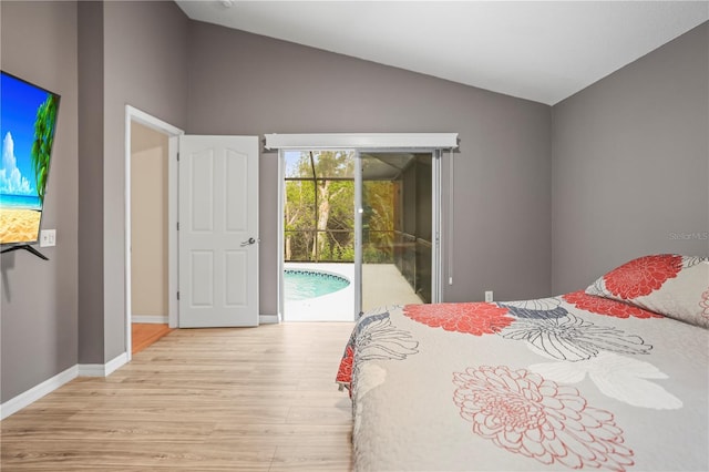 826 Addison Dr NE, Saint Petersburg, FL 33716 - bedroom featuring access to outside, light wood-style flooring, and vaulted ceiling