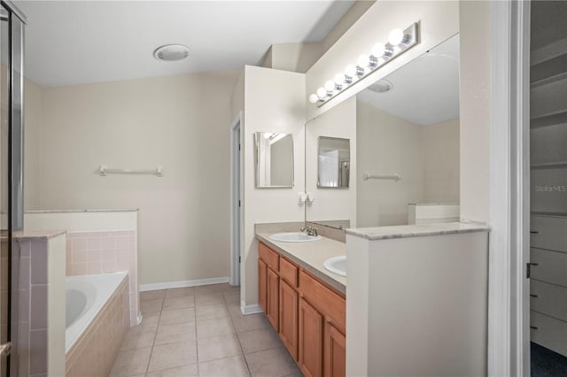 826 Addison Dr NE, Saint Petersburg, FL 33716 - bathroom featuring double vanity, a bath, and tile patterned flooring