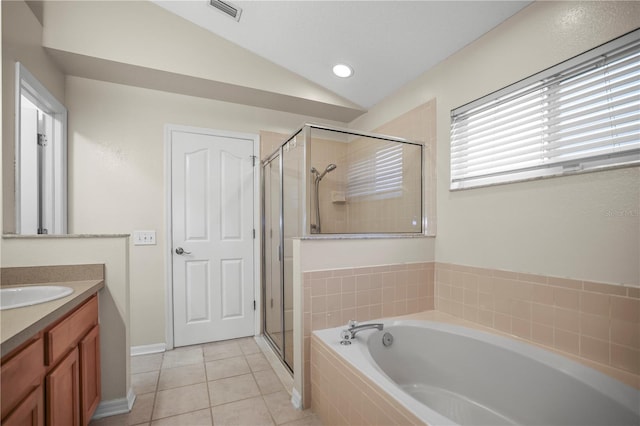 826 Addison Dr NE, Saint Petersburg, FL 33716 - full bath featuring vanity, a garden tub, vaulted ceiling, a stall shower, and tile patterned floors