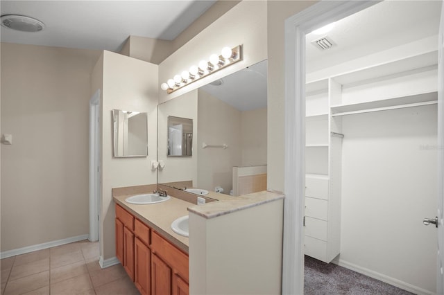 826 Addison Dr NE, Saint Petersburg, FL 33716 - full bath with double vanity, a spacious closet, and tile patterned flooring