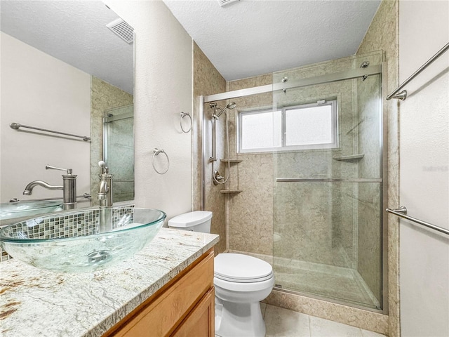 826 Addison Dr NE, Saint Petersburg, FL 33716 - bathroom featuring vanity, a stall shower, tile patterned floors, and a textured ceiling