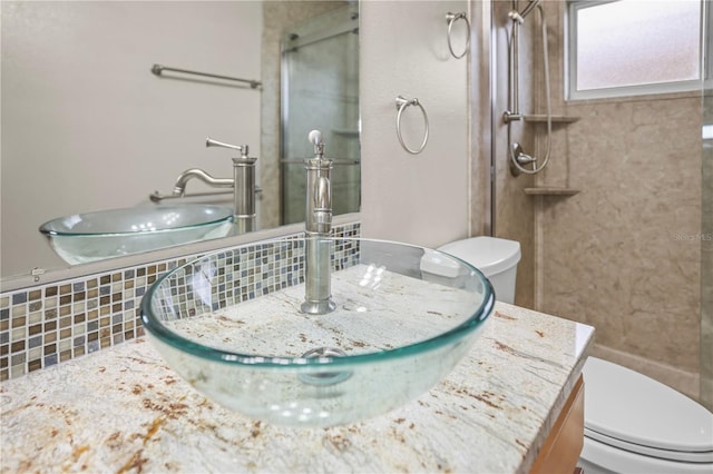 826 Addison Dr NE, Saint Petersburg, FL 33716 - bathroom featuring a shower with door, vanity, and tasteful backsplash