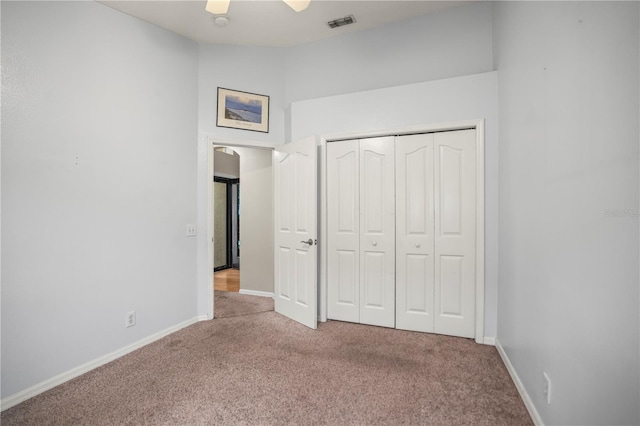 826 Addison Dr NE, Saint Petersburg, FL 33716 - unfurnished bedroom with carpet flooring, a closet, and ceiling fan