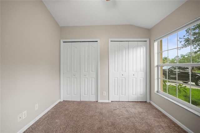 826 Addison Dr NE, Saint Petersburg, FL 33716 - unfurnished bedroom featuring lofted ceiling, multiple closets, and carpet flooring