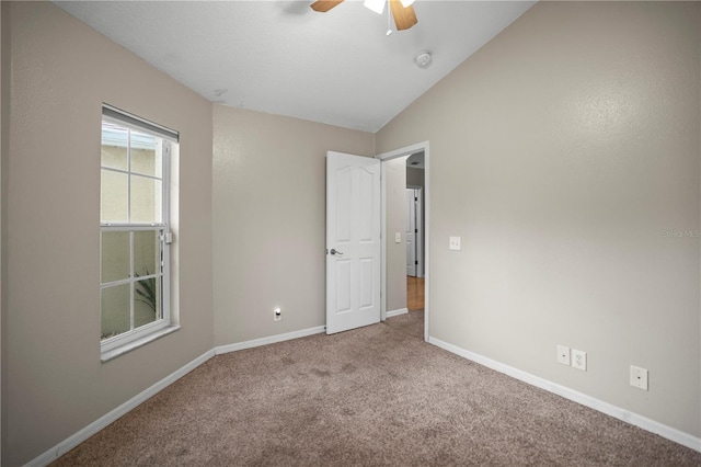 826 Addison Dr NE, Saint Petersburg, FL 33716 - unfurnished bedroom with carpet flooring, lofted ceiling, and a ceiling fan