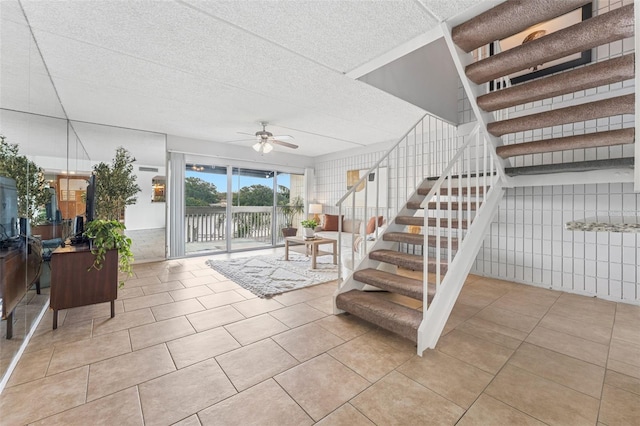 2424 W Tampa Bay Blvd Unit G204, Tampa, FL 33607 - stairs featuring ceiling fan, tile patterned flooring, and a textured ceiling