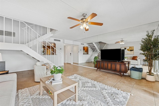 2424 W Tampa Bay Blvd Unit G204, Tampa, FL 33607 - tiled living room with ceiling fan and stairs