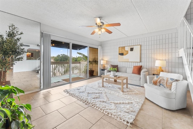 2424 W Tampa Bay Blvd Unit G204, Tampa, FL 33607 - tiled living room with ceiling fan and a textured ceiling