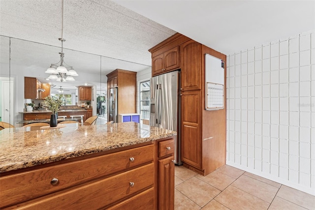 2424 W Tampa Bay Blvd Unit G204, Tampa, FL 33607 - kitchen featuring stainless steel fridge, light stone countertops, and brown cabinetry
