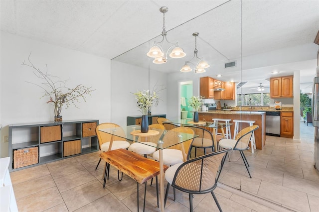 2424 W Tampa Bay Blvd Unit G204, Tampa, FL 33607 - dining space featuring light tile patterned floors, a chandelier, and a textured ceiling