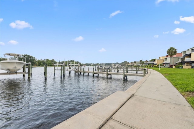 2424 W Tampa Bay Blvd Unit G204, Tampa, FL 33607 - dock featuring boat lift, a water view, and a lawn